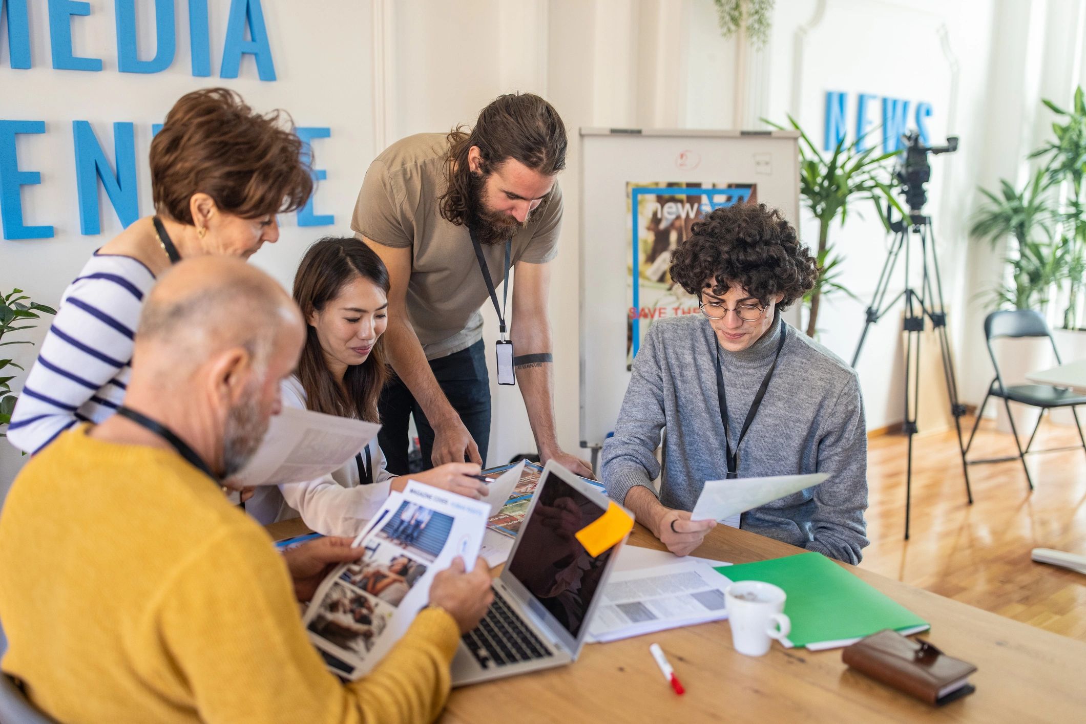 Editors collaborating in a modern newsroom